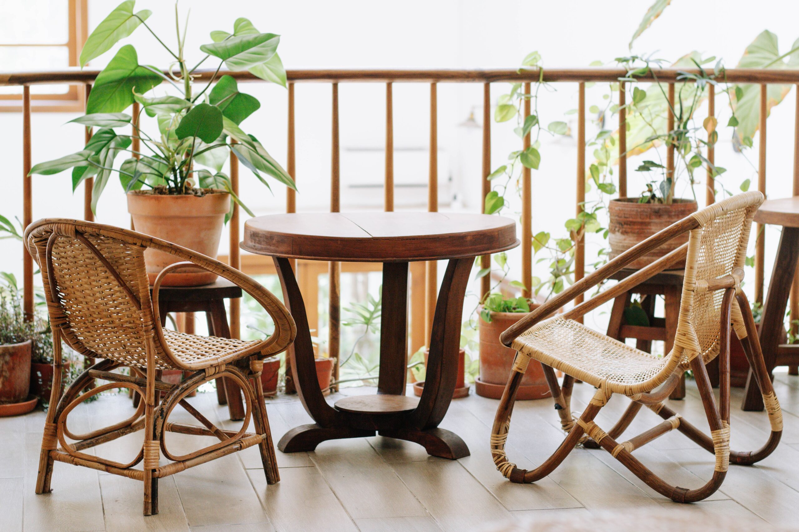 apartment balcony with table, chairs, and plants