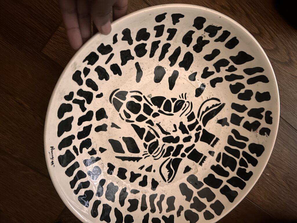 Black and white plate with giraffe print and portrait of giraffe in the middle