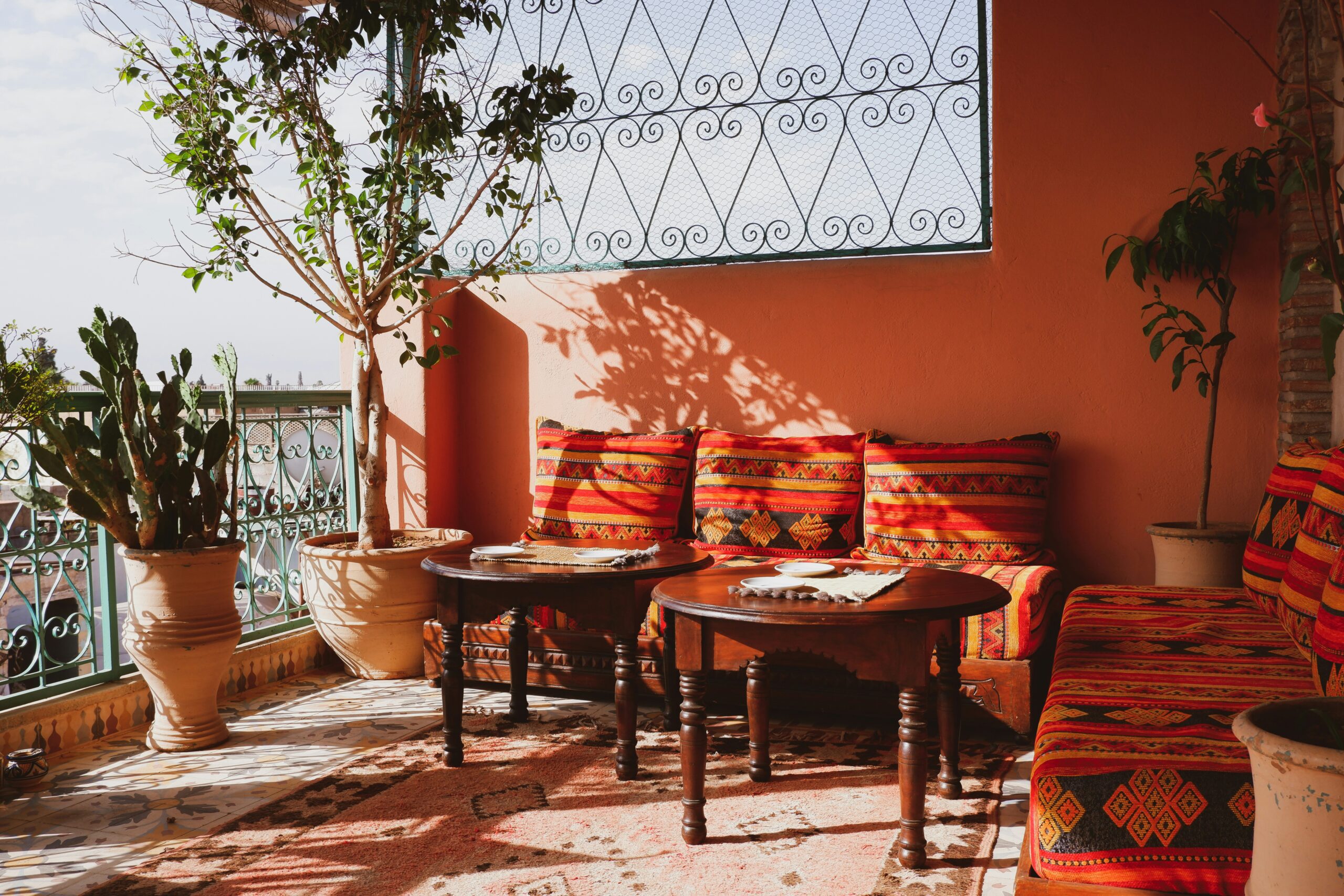 boho decor on balcony with bright orange and red