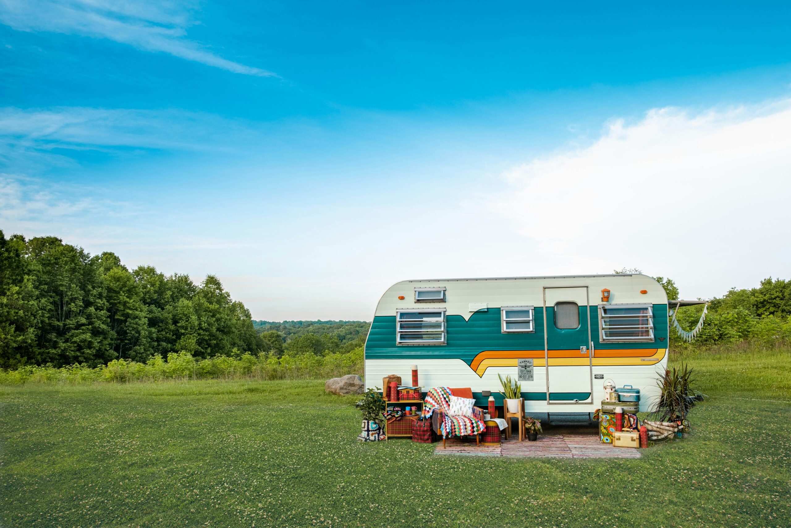 Mobile home parked on a green pasture